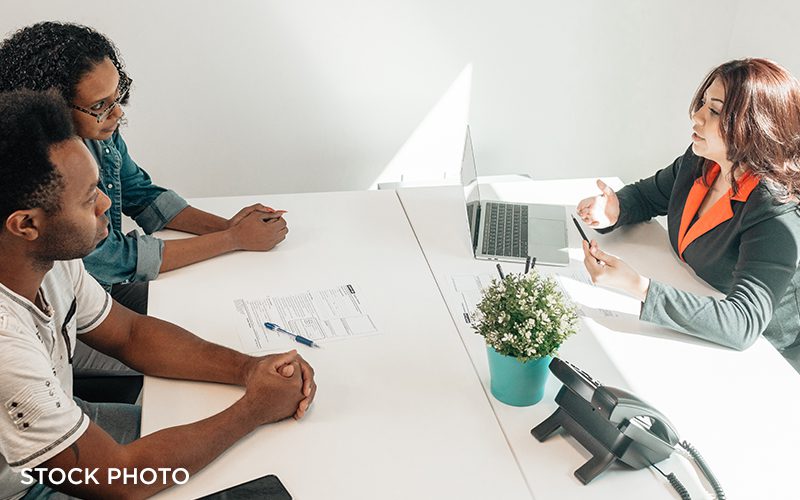 An attorney consulting with clients in her office.